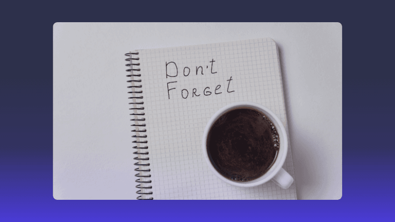 White notebook with 'Don't Forget' written, next to a white cup of coffee.