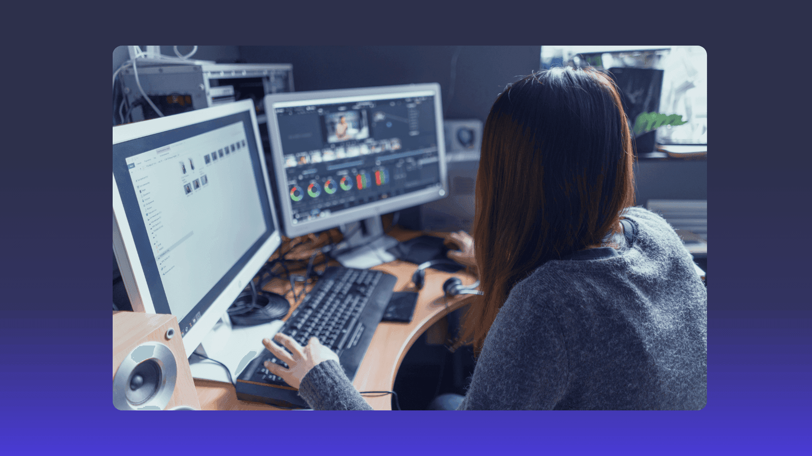 A person working on two computer screens, focusing on video editing software.