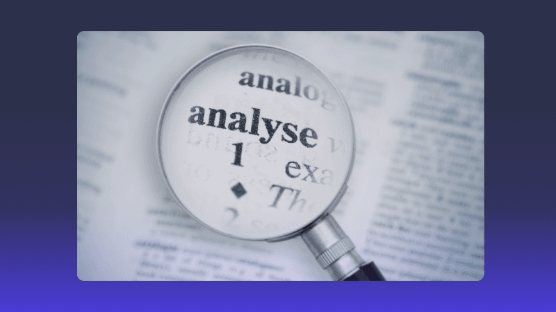 Magnifying glass highlighting the word 'analyse' in a dictionary, symbolizing detailed study.